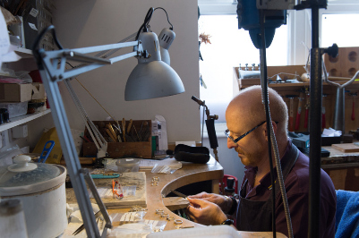 Malcolm Morris working on the jewellery bench in his london workshop creating silver and gold designer jewellery